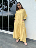 Woman wearing yellow cotton kurta with straight pants and side pockets