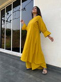 Yellow kurta and palazzo set for women showing flared silhouette and bell sleeves