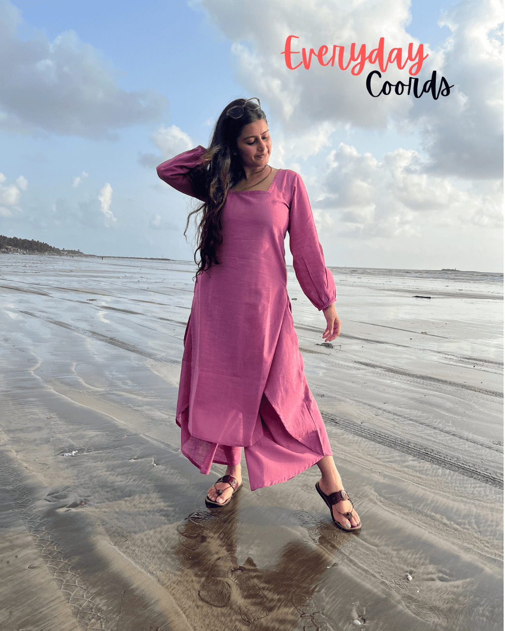 Woman in a pink dress standing on a beach with 'Everyday Coords' 